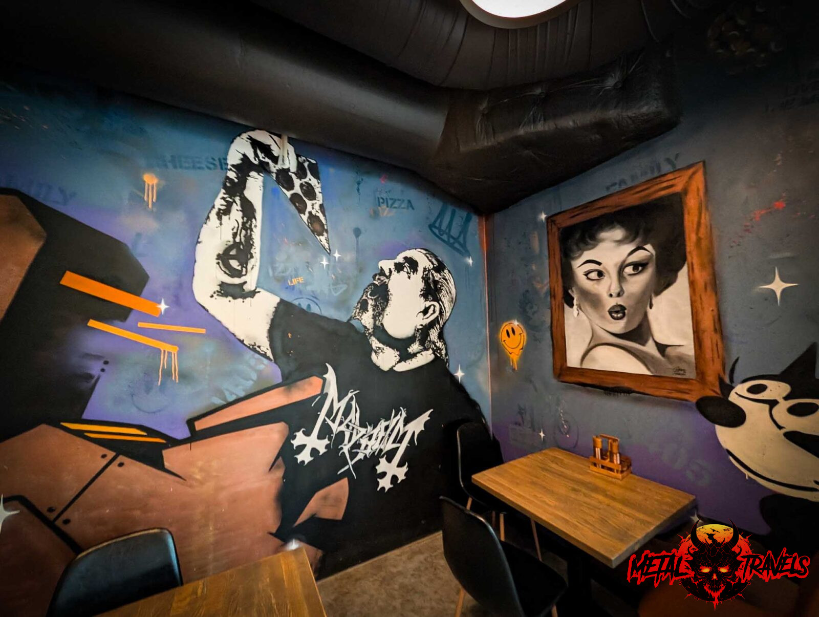 Pizzeria-Melvin-04 Man eating pizza with Mayhem Shirt Wall art at Pizzeria Melvin